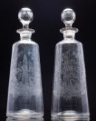 A pair of unusual Irish glass 'Whiskey' and 'Brandy' decanters and stoppers each engraved with