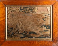 An early 19th century needlework picture of a hare crouching amongst foliage,