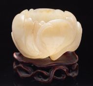 A Chinese carved jade Lotus waterpot in the form of an open lotus flower with an overlapping leaf