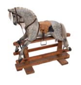 A painted and carved wood rocking horse,