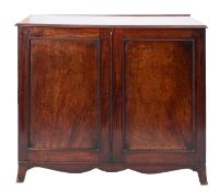 A Regency mahogany press cupboard, circa 1815; the top with moulded edges,
