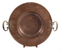 A planished copper and brass mounted bowl, perhaps Ottoman, 19th century; the broad, flat rim,