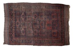 A Balouch carpet, the panelled field with geometric medallions and designs,
