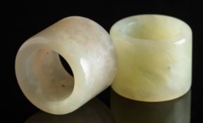 Two jade archers rings of pale mottled colour, 35mm diameter each.