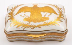 A French porcelain musical box, with gilt metal mounts painted in gold with a displaying eagle.