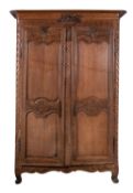 A Louis XV carved oak armoire,