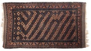 A Balouch rug, the diagonal striped field with stepped and cruciform medallions,