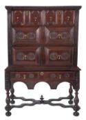A 17th Century and later oak chest on a 19th Century stand, having carved rosette ornament,