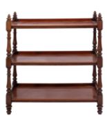 A Victorian mahogany three tier buffet, mid 19th century; with turned finials at the upper corners,