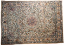 A Meshed carpet, the beige field with a central circular pole medallion,