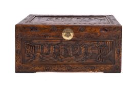A Chinese carved and stained hardwood, probably camphorwood, coffer,