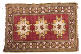 A Caucasian rug, the wine field with triple beige and pistachio cruciform Lesghi medallions,