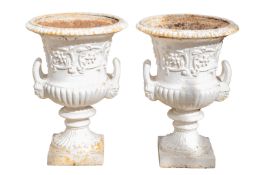 A pair of white painted cast iron twin handled garden urns,