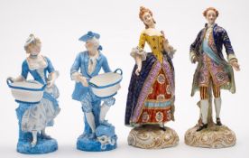 A pair of Paris porcelain figures of dandy and companion on gilt decorated rococo bases,