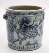 A Chinese porcelain jar of cylinder form with mask handles painted in blue front and verso