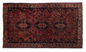 A Lori rug, the rose field with triple indigo hexagonal hooked pole medallions,