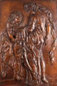 A relief sculpted walnut rectangular figural panel depicting Judith with the head of Holofernes,