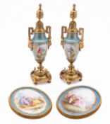 A pair of Sèrves-style gilt-metal mounted porcelain urns and finials and a pair of similar oval
