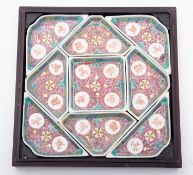 A Straits Chinese porcelain hors d'oeuvre set comprising nine trays decorated with scrolling