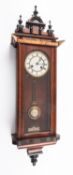 An Edwardian mahogany and glass Vienna-style wall regulator having an eight-day duration