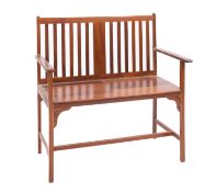 A stained hardwood two seat hall bench, second half 20th Century; with openwork lath back,
