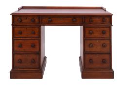 A Regency mahogany twin pedestal desk, circa 1815; the top with moulded outscrolled gallery,
