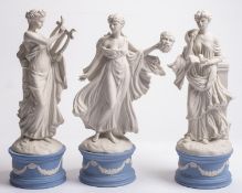 Three Wedgwood bisque Muses raised on circular pale blue jasper ware bases, comprising Calliope,
