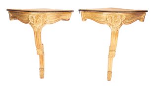 A pair of carved and giltwood bow front corner console tables in Louis XV style,
