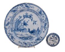 An 18th century English blue and white delftware plate and a Bovey Tracey inscribed and dated