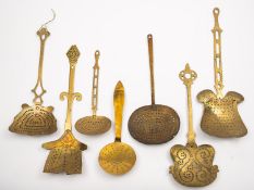 A collection of thirteen brass skimmers in 17th and 18th century styles,