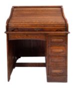An oak tambour top desk,