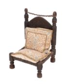 A Northwest Indian carved hardwood low chair,