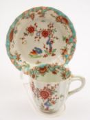 A First Period Worcester 'Two Quail' coffee cup and saucer of lobed form with entwined branch handle