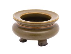 A small Chinese 'Tea Dust' glazed censer, of bombe form on three feet,