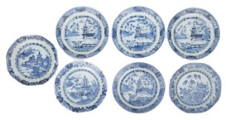 Seven Chinese porcelain plates each decorated in blue variously with lakeside temples,
