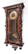 A stained wood Vienna style wall regulator having an eight-day duration skeletonised spring driven