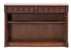 A carved oak open bookcase in Gothic style,