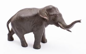 A Japanese bronze elephant, signed Seiya, Meiji period naturalistically modelled with trunk raised,