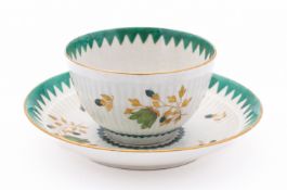A First Period Worcester teabowl and saucer of semi-reeded form,