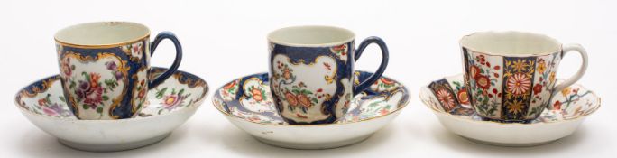 A group of three First Period Worcester coffee cups and saucers the first of fluted form painted in