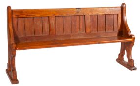 A pair of pine pews, in Reformed Gothic taste, circa 1900; with rectangular panel backs,