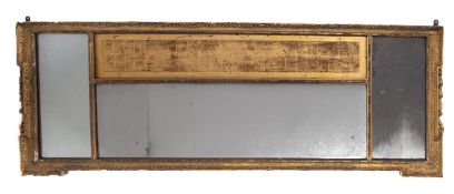 An early 19th Century carved giltwood and gesso rectangular overmantel mirror, of broken outline,