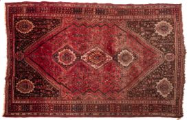 A Shiraz carpet, the rose hexagonal field with triple hexagonal stepped medallions,