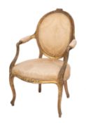 A George III giltwood elbow chair, late 18th Century; the oval backrest,