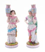 A pair of French bisque figures of Eastern water carriers wearing floral decorated robes and on
