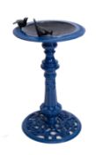 A blue painted cast iron bird bath,