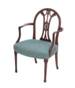 A carved mahogany and upholstered library elbow chair in George III style,