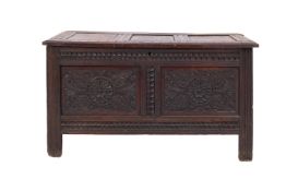 A Jacobean oak coffer, second half 17th Century and later elements; with hinged three panel cover,