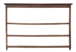 A George III oak wall mounting Delft rack,