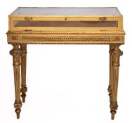 A giltwood and glazed bijouterie table in Empire style,
